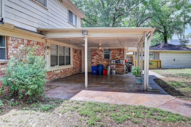 view of patio featuring fence and a carport