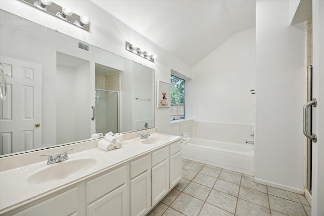 full bathroom featuring a sink, tile patterned floors, vaulted ceiling, and a stall shower
