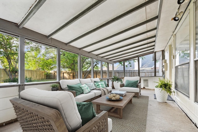 sunroom featuring an outdoor hangout area and beam ceiling