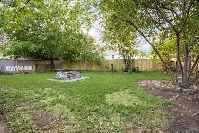 view of yard featuring a fenced backyard and an outdoor fire pit