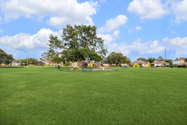 view of home's community featuring a yard and playground community
