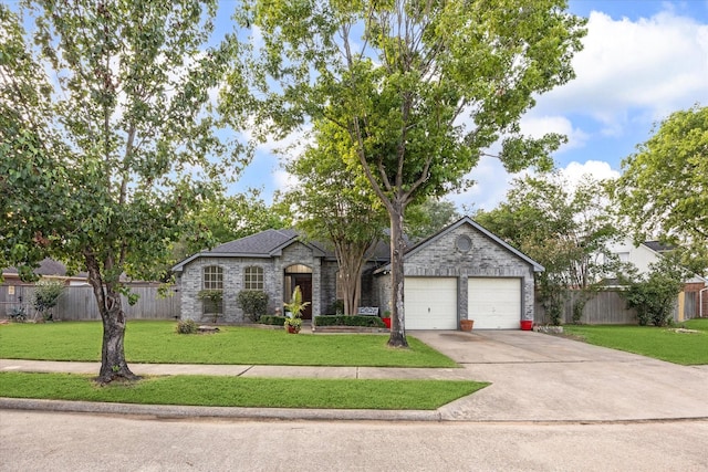 view of front of home featuring concrete driveway, fence, and a front yard
