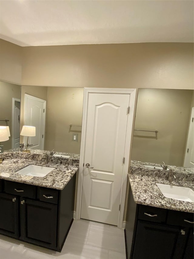 bathroom featuring a sink and two vanities