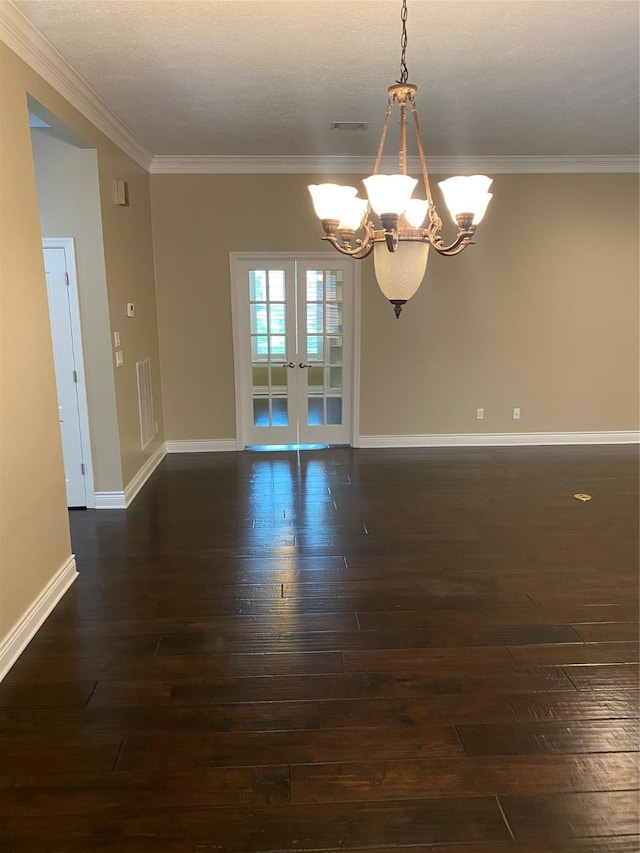 empty room featuring french doors, dark wood-style flooring, visible vents, an inviting chandelier, and ornamental molding