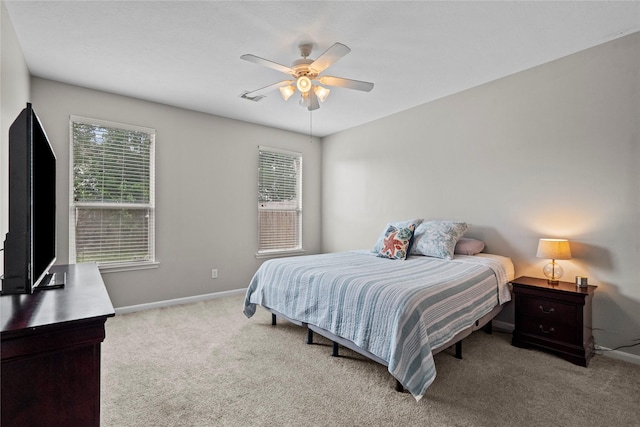 carpeted bedroom featuring baseboards and a ceiling fan