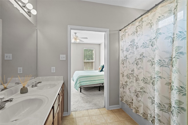 ensuite bathroom featuring double vanity, a shower with curtain, a sink, and tile patterned flooring