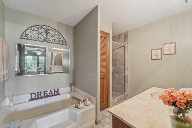 bathroom with a garden tub, a textured ceiling, and a shower stall