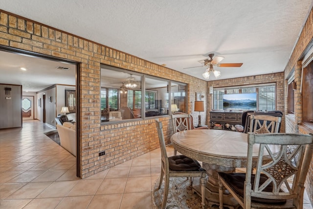 dining room featuring visible vents, a textured ceiling, ceiling fan, and light tile patterned flooring