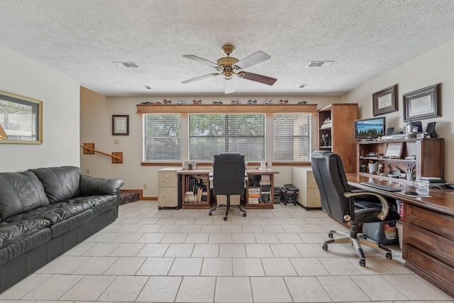 office area with visible vents, a textured ceiling, and ceiling fan