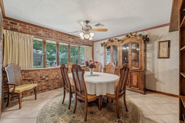 dining room with visible vents, a textured ceiling, ceiling fan, and light tile patterned flooring