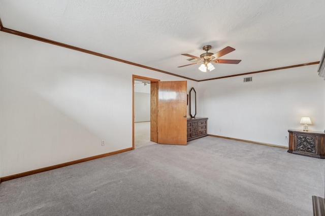 interior space featuring crown molding, a ceiling fan, and baseboards