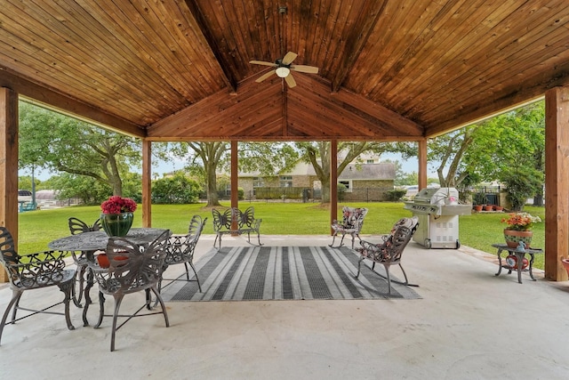 view of patio with outdoor dining area, a ceiling fan, and area for grilling