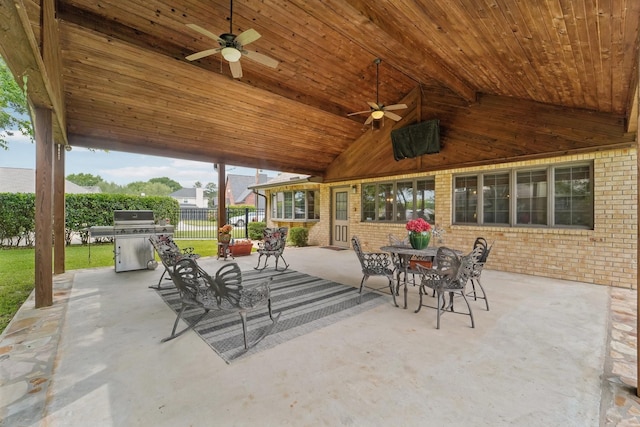 view of patio / terrace with a ceiling fan, fence, area for grilling, and outdoor dining space
