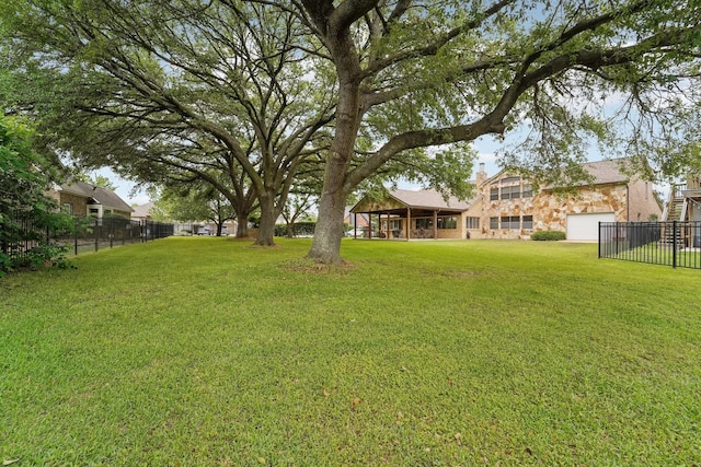 view of yard with a garage and fence
