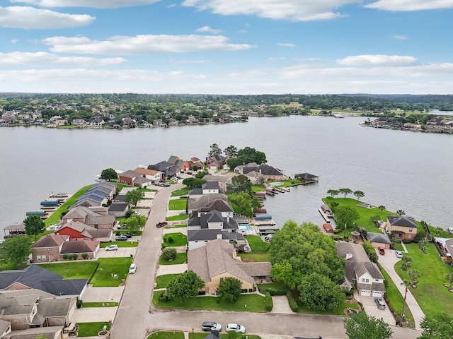 drone / aerial view with a water view and a residential view