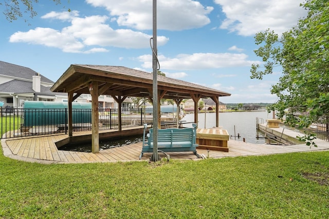 dock area featuring a lawn and a water view