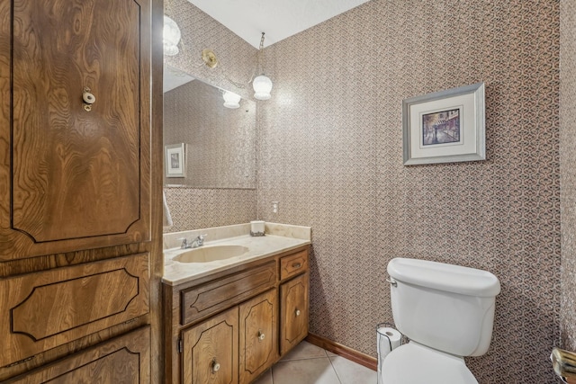 bathroom with vanity, tile patterned flooring, toilet, and wallpapered walls