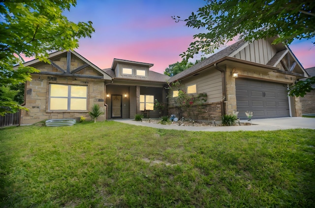 craftsman inspired home with a lawn, stone siding, board and batten siding, an attached garage, and driveway
