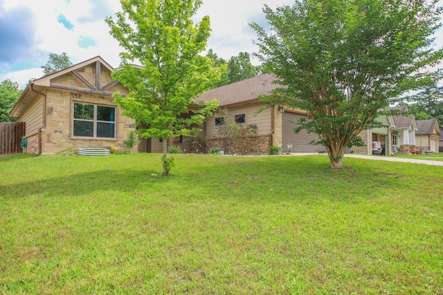 view of front of house with a front lawn, stone siding, and a garage