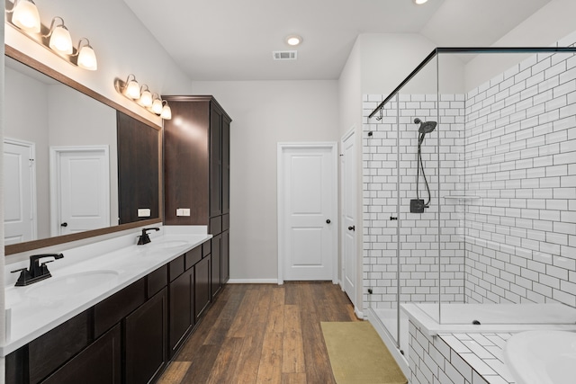 bathroom with visible vents, a sink, and a stall shower