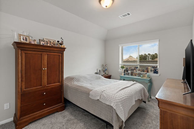 carpeted bedroom featuring visible vents, baseboards, and lofted ceiling