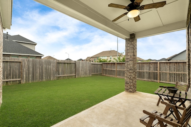 view of yard with a patio, ceiling fan, and a fenced backyard