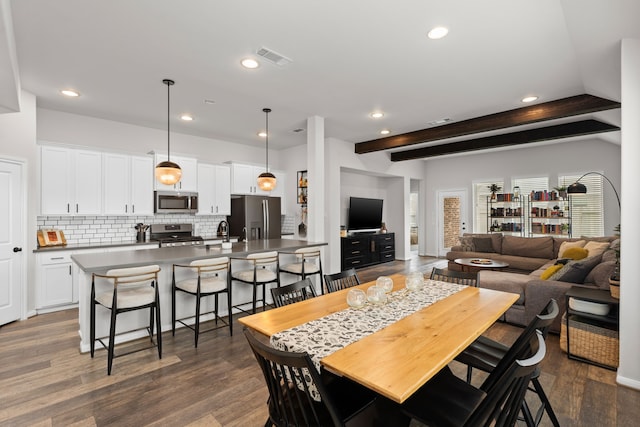 dining room featuring recessed lighting, dark wood-type flooring, visible vents, and beamed ceiling