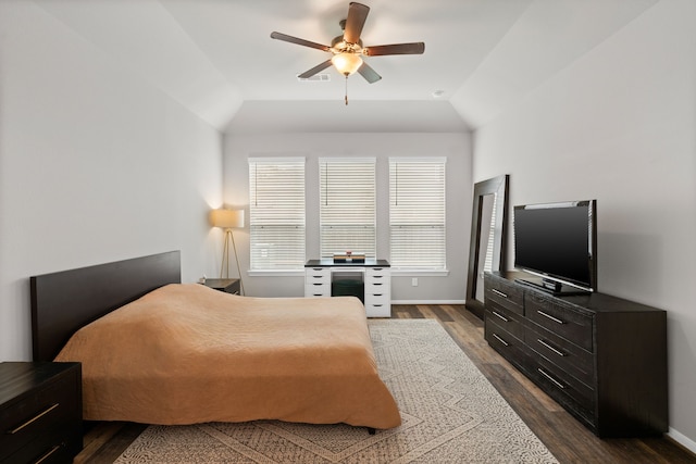 bedroom with baseboards, a ceiling fan, and dark wood finished floors