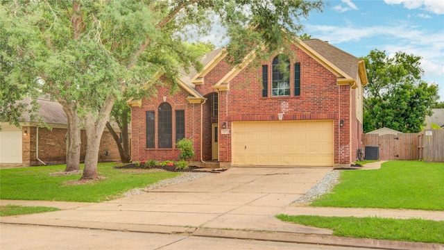 107 Mango St, Lake Jackson, TX 77566 - traditional home featuring fence, driveway, a front yard, and a garage