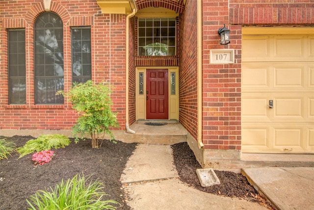 107 Mango St, Lake Jackson, TX 77566 - doorway to property with brick siding and a garage