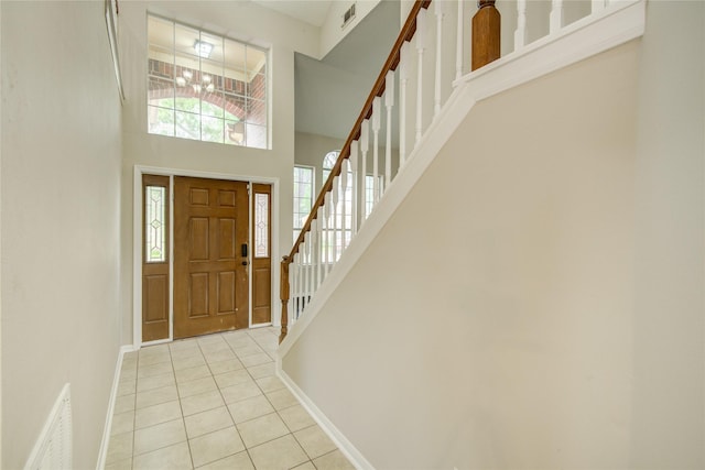 107 Mango St, Lake Jackson, TX 77566 - foyer with visible vents, stairs, a towering ceiling, and light tile patterned floors