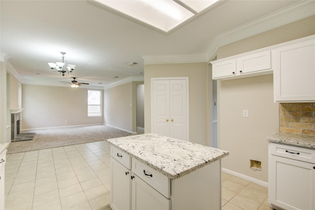107 Mango St, Lake Jackson, TX 77566 - kitchen with light colored carpet, white cabinetry, baseboards, tasteful backsplash, and ornamental molding