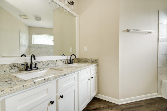 107 Mango St, Lake Jackson, TX 77566 - bathroom featuring a sink, baseboards, and wood finished floors