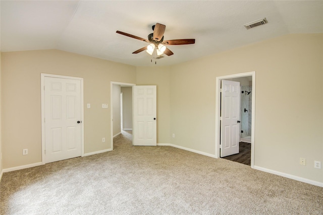 107 Mango St, Lake Jackson, TX 77566 - unfurnished bedroom with carpet floors, baseboards, visible vents, and lofted ceiling