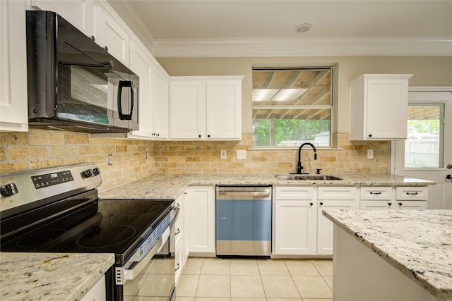 107 Mango St, Lake Jackson, TX 77566 - kitchen with crown molding, light tile patterned flooring, white cabinets, a sink, and stainless steel appliances