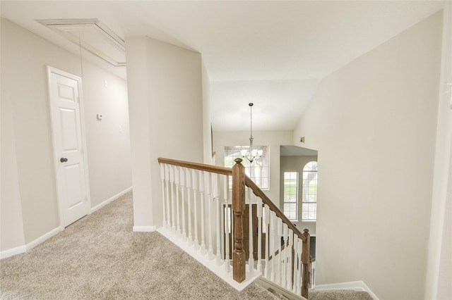 107 Mango St, Lake Jackson, TX 77566 - corridor featuring a chandelier, carpet, attic access, baseboards, and an upstairs landing