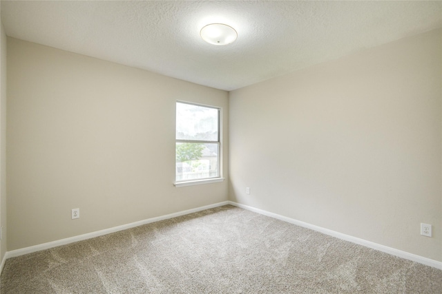 107 Mango St, Lake Jackson, TX 77566 - spare room featuring baseboards, carpet flooring, and a textured ceiling