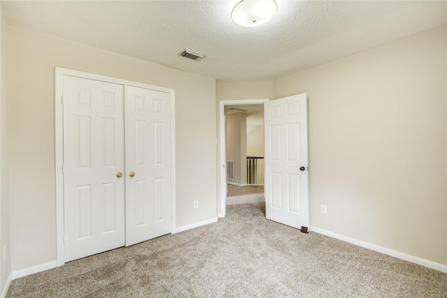 107 Mango St, Lake Jackson, TX 77566 - unfurnished bedroom featuring carpet flooring, baseboards, visible vents, and a closet
