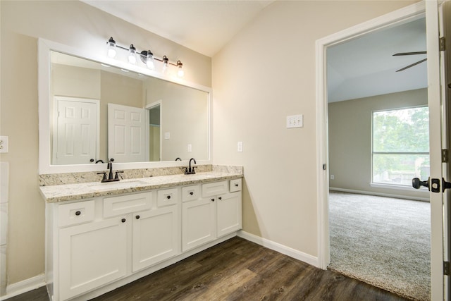 107 Mango St, Lake Jackson, TX 77566 - bathroom with double vanity, a sink, baseboards, and wood finished floors