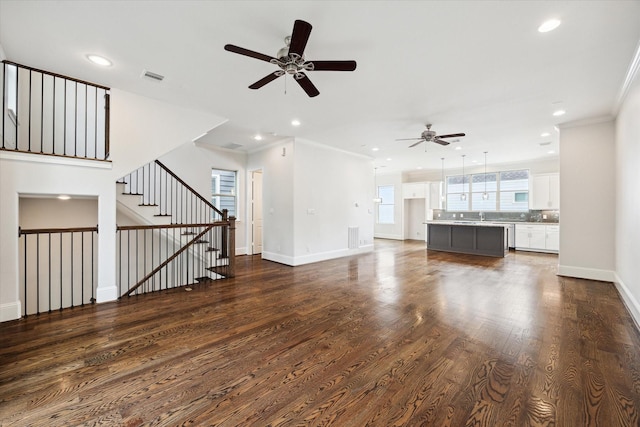 1230 W 25th St Unit C, Houston, TX 77008 - unfurnished living room with dark wood-type flooring, visible vents, ceiling fan, crown molding, and baseboards