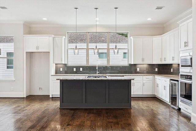 1230 W 25th St Unit C, Houston, TX 77008 - kitchen featuring a sink, wine cooler, crown molding, decorative backsplash, and white cabinets