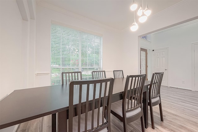 dining room with crown molding and wood finished floors