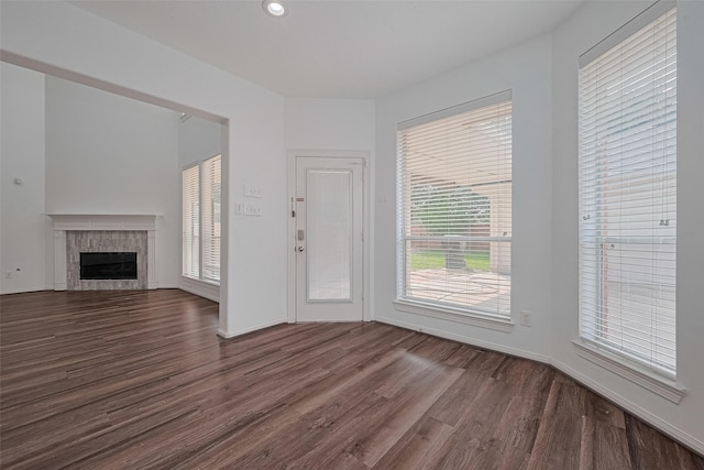 15014 Cabin Run Ln, Sugar Land, TX 77498 - unfurnished living room featuring dark wood finished floors, a tile fireplace, baseboards, and recessed lighting