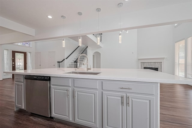 15014 Cabin Run Ln, Sugar Land, TX 77498 - kitchen with dishwasher, a sink, open floor plan, a high end fireplace, and dark wood-style floors