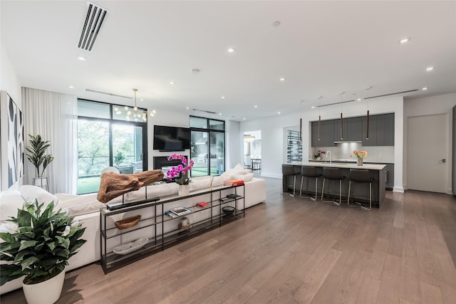 living room featuring recessed lighting, visible vents, and light wood-type flooring