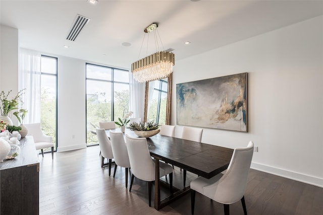 dining room with a chandelier, baseboards, visible vents, and dark wood-style floors