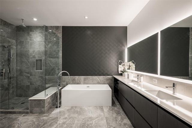 2710 Steel St Unit 301, Houston, TX 77098 - bathroom featuring a soaking tub, a shower stall, double vanity, tile walls, and marble finish floors