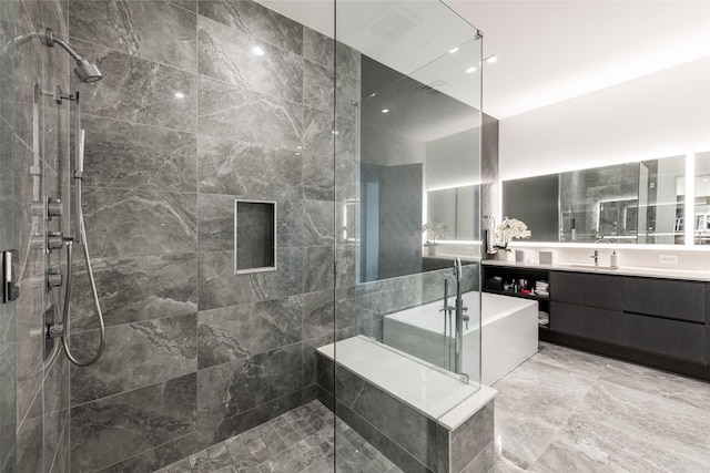 full bathroom with vanity, a freestanding bath, and a stall shower