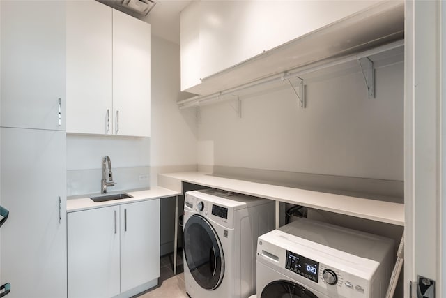 2710 Steel St Unit 301, Houston, TX 77098 - laundry area featuring cabinet space, separate washer and dryer, and light tile patterned flooring