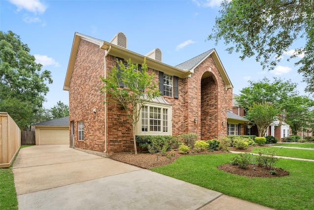 4423 Nassau Dr, Sugar Land, TX 77479 - traditional-style house featuring brick siding, fence, a chimney, and a front lawn
